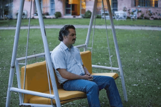 Pablo Escobar from Narcos waiting alone on a swing
